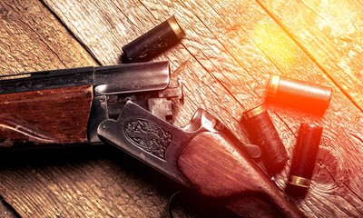 Vintage rifle and sleeves on wooden table