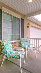 Vertical Facade of a home with a view of the green front door and white garage door
