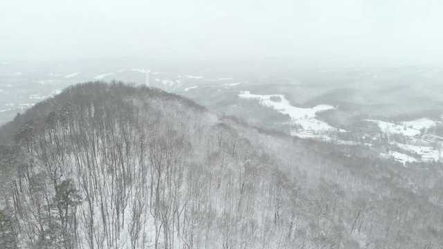 Drone Aerial over Mountains with Snow Falling
