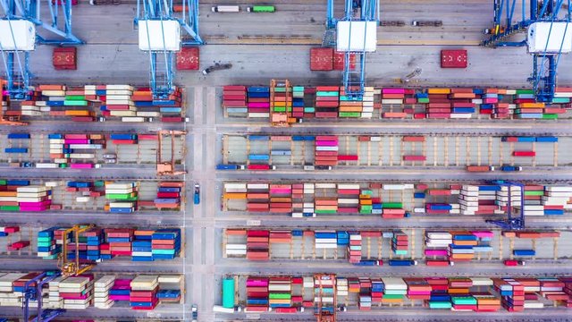 4k, Hyper lapse aerial view container cargo ship loading and unloading in deep sea port, Aerial top view of logistic import export transportation business by container ship in open sea.