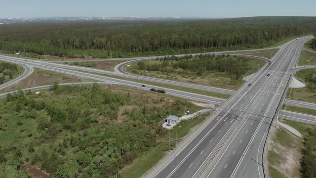 Military vehicles are on the side of the road in front of the bridge. Aerial view 4K