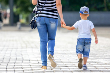 woman with a child goes through the crosswalk