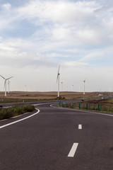 Fototapeta na wymiar A windmill that generates electricity on the prairie
