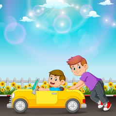 Obraz na płótnie Canvas the boy is pushing his friend's car in the road 