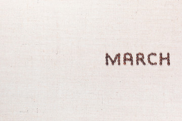The word March written with coffee beans shot from above, aligned to the right.