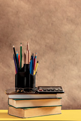 Back to school concept. Stack of books with school supplies