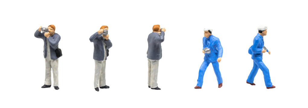 Miniature figurine character as photographer standing and working in posture isolated on white background.