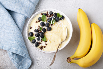 Banana dairy free nice cream or smoothie bowl topped with blueberry overhead
