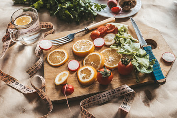 Healthy vegan food background with cutting board and lemon slices. Top view to organic food...