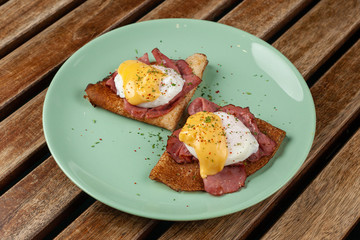 Crepes with poached egg, grilled bacon, cheese and herbs