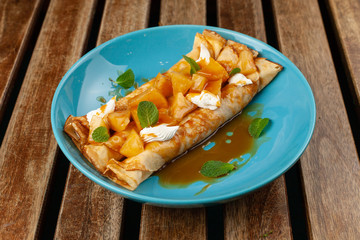 Crepes with tropical pineapple, cream cheese and caramel sauce