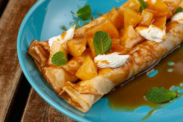 Russian sweet blini with pineapple, cream cheese and caramel sauce for shrovetide