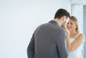 Loving and romantic couple is kissing with dance together on white background,Enjoying in wedding day
