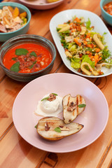 Variety of vegetarian meals: poke bowl, gazpacho, vegetable salads, BBQ fruits and vegan noodle soup