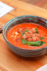 Cold spanish gazpacho with basil and herbs for detox diet diner