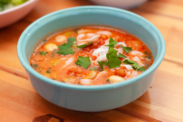 Vegetarian spicy soup with vegetable broth, mushrooms and ribbon noodles
