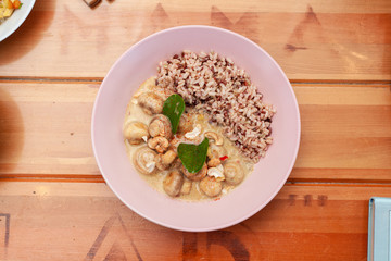 Vegetarian nutritious lunch with boiled wild rice and champignons in a coconut milk gravy