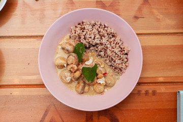 Vegetarian nutritious lunch with boiled wild rice and champignons in a coconut milk gravy