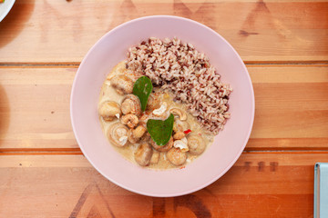 Vegetarian nutritious lunch with boiled wild rice and champignons in a coconut milk gravy