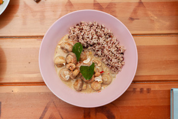 Vegetarian nutritious lunch with boiled wild rice and champignons in a coconut milk gravy