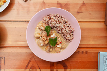 Vegetarian nutritious lunch with boiled wild rice and champignons in a coconut milk gravy