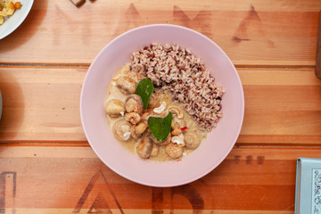 Vegetarian nutritious lunch with boiled wild rice and champignons in a coconut milk gravy