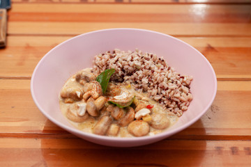 Vegetarian nutritious lunch with boiled wild rice and champignons in a coconut milk gravy