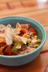 Hipster poke bowl with avocado, tomatoes, quinoa, rice, potato and grilled pumpkin for a vegetarian lunch