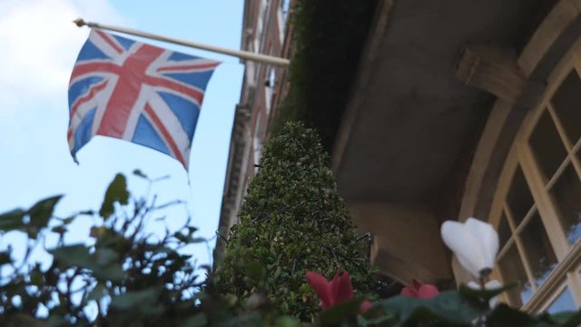 Low angle view of a British flag waving on a wall.