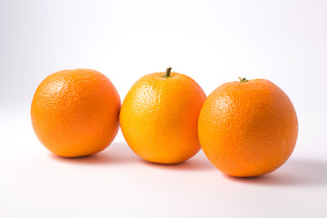 Glass jar with orange jam and orange on white background