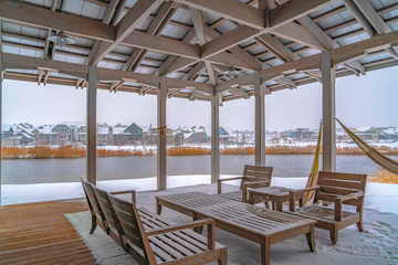 Fototapeta na wymiar Snowy patio of a clubhouse overlooking Oquirh Lake