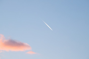 The wake of an airplane at sunset. Val d'Orcia, Siena, Tuscany, Italy - May, 2019.
