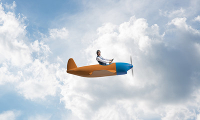 Man in aviator hat driving propeller plane © adam121