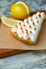 Lemon tart . Gray textured background. Beautiful serving dishes. Dessert. Food chain