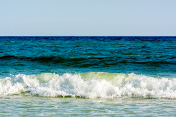 Green Ocean Wave on Blur Blue Ocean Water Background