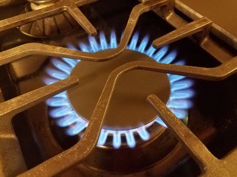 Blue Flame On Natural Gas Stove Top With Metal Grate