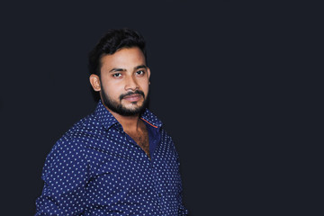 portrait of a young man model with black background casual dress