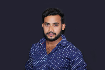 Fototapeta premium portrait of a young man model with black background front view