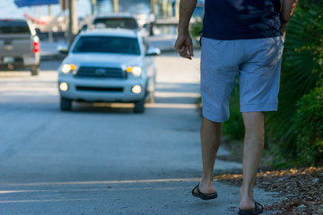 Man Walking on the Street on Blur Car Background. Destin Beach, Florida