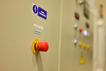 Safety red mushroom button on switchboard.