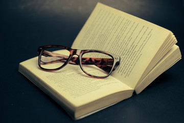 open book and glasses with vintage style