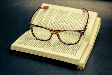 open book and glasses with vintage style