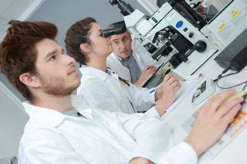 medical students working with microscope at the university