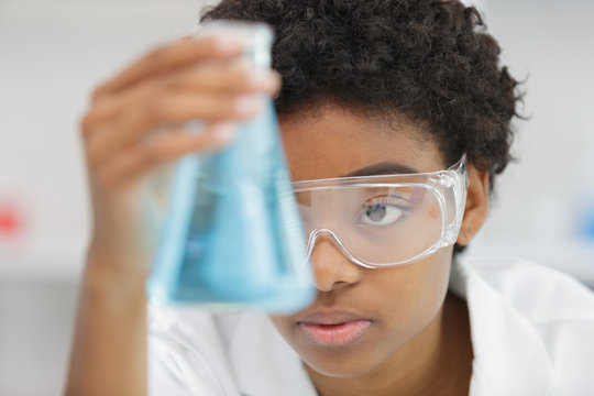 Woman In The Lab Holding A Flask