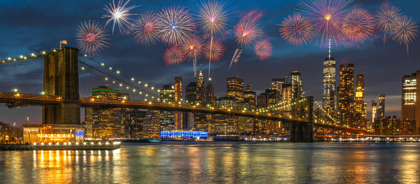 Banner Multicolor Firework Celebration over New york Cityscape with Brooklyn Bridge over the east river at the twilight time, USA downtown skyline,  4th of July and Independence day concept - Powered by Adobe