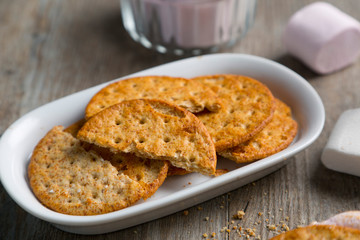 Crackers with cream cheese on wood table