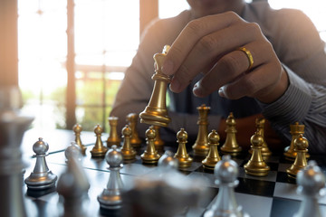 Close-up photos of checkmate hands on a chessboard during a chess game The concept of business victory strategy wins the intelligence game.