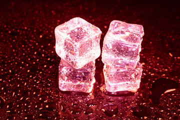 ice cubes on a reflections red light.