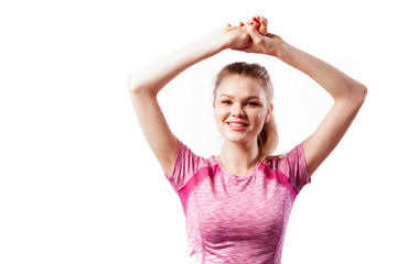 Fototapeta na wymiar Sporty woman in t-shirt and shorts smilling, posing and holds hands above head on white isolated background. Photo of muscular woman in sportswear on white background. Strength and motivation.