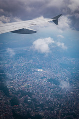 Fototapeta premium Airplane wing in the porthole overlooking the city of Kiev, Ukraine